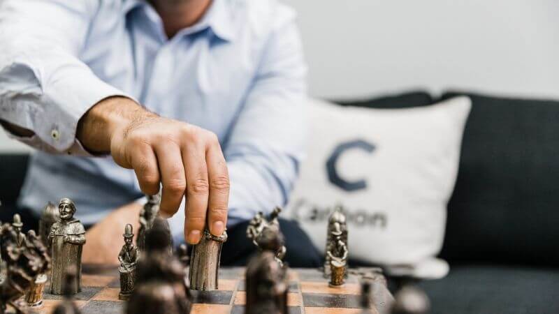 Man playing chess in Carbon office